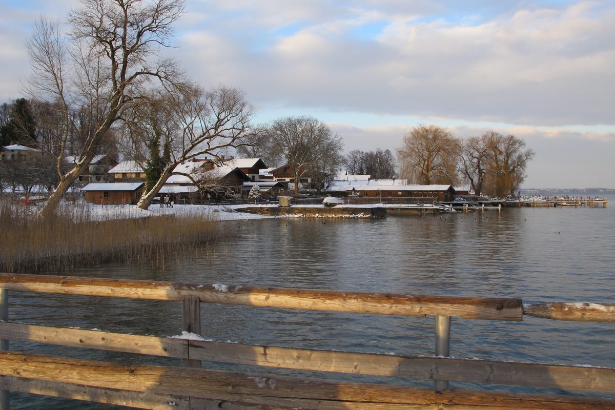 Fraueninsel village and boathouses at dusk in winter