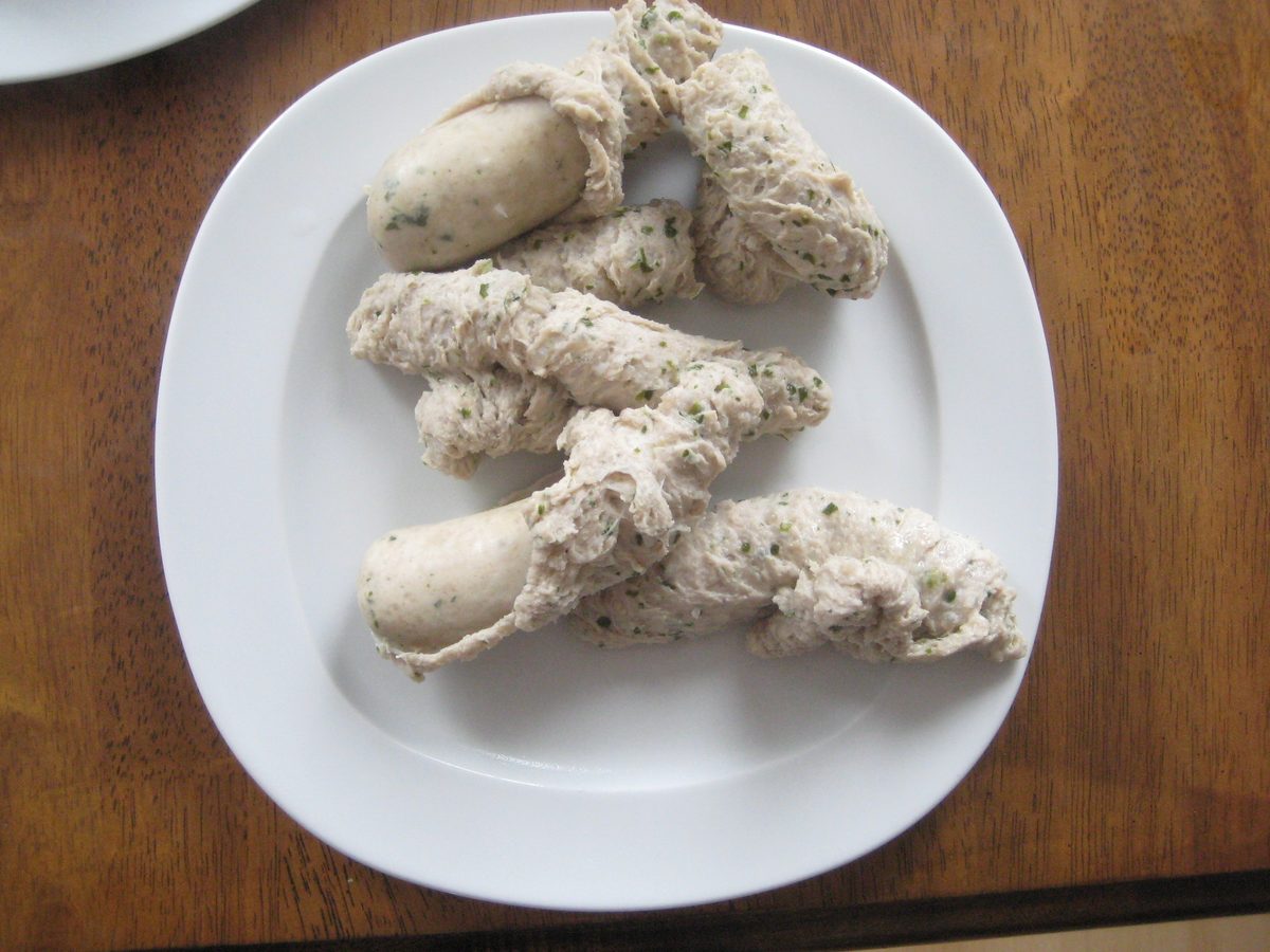 Empty Weisswurst skins left on a plate